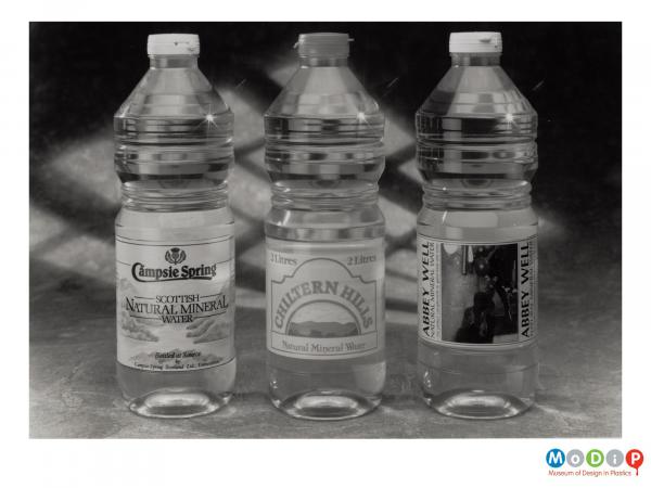Scanned image showing 3 spring water bottles.