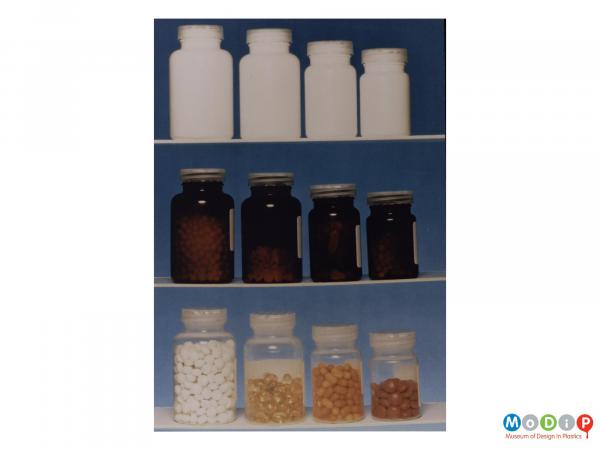 Scanned image showing a range of medicine bottles in white, translucent brown and clear.