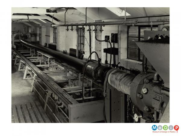 Scanned image showing a large pipe being extruded.