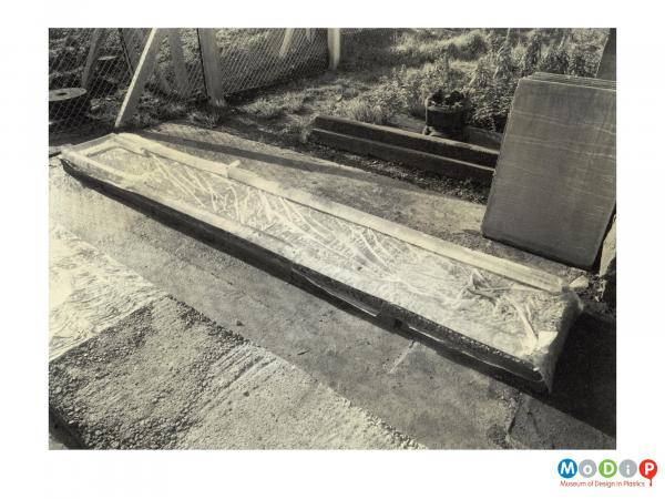 Scanned image showing concrete moulds lined with polythene sheet.