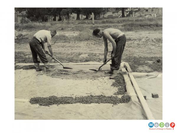 Scanned image showing a damp course being laid.