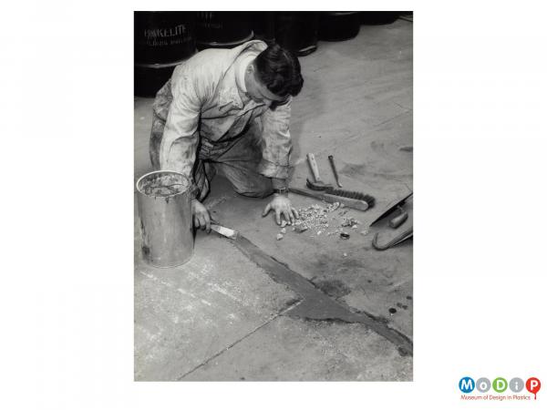 Scanned image showing repairs being made to concrete.