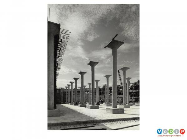 Scanned image showing concrete pillars made in plastic moulds.