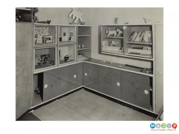 Scanned image showing fitted nursery furniture.