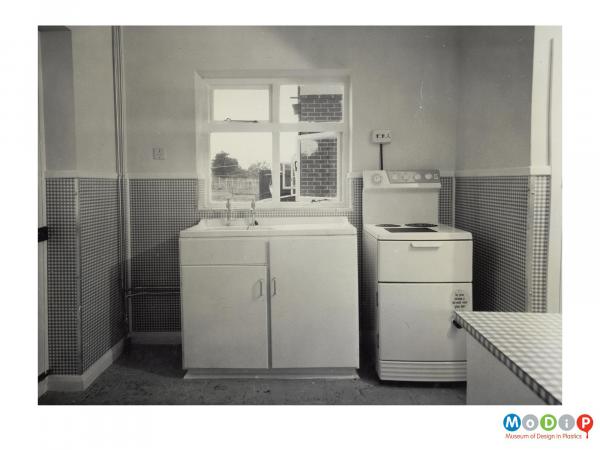 Scanned image showing a kitchen with wall panels.