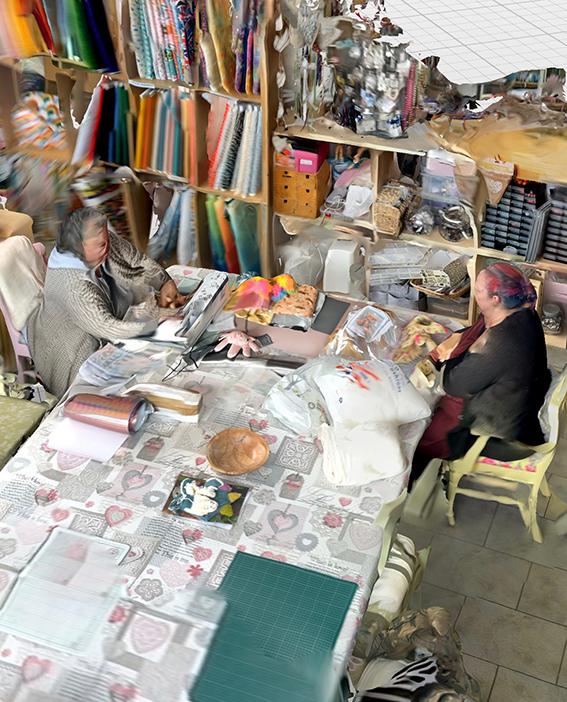 A 3D scan of two women at a sewing table surrounded by haberdashery