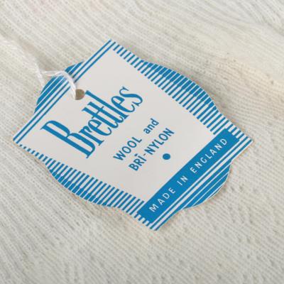 Close view of the paper swing tag of a pair of long-legged knickers.