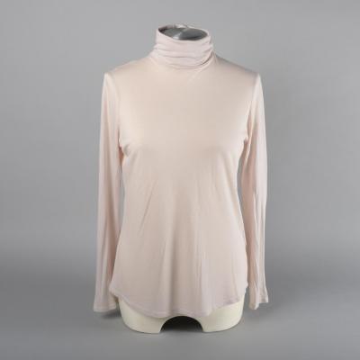 Front view of a roll neck top.