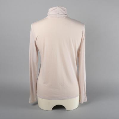 Rear view of a roll neck top.