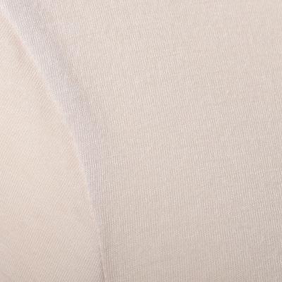 Close view of the fabric of the neck of a roll neck jumper.