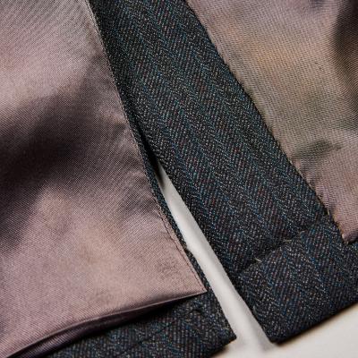 Close view of the lining and vent of a man's jacket.
