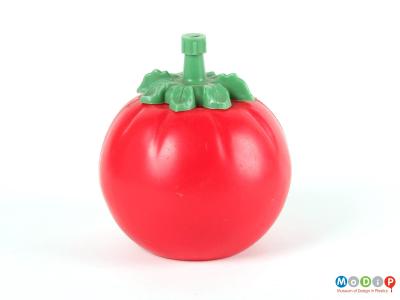 Side view of a tomato sauce bottle showing the round bottle with leaf shaped lid.