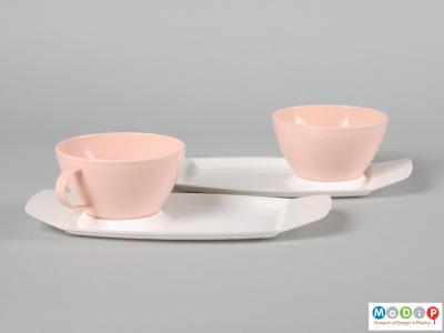 Side view of a Silvant cups and trays set showing the cups sitting in the recesses on the trays.