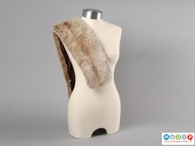 Front view of a synthetic fur scarf showing the scarf draped over one shoulder of a mannequin.
