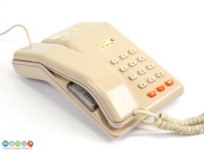 Top view of a telephone showing the push buttons and angular handset.