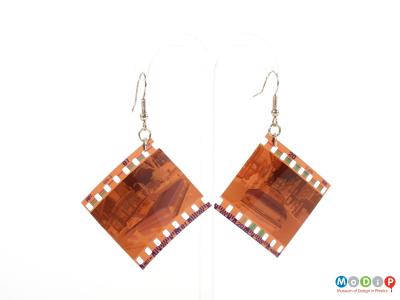 Front view of a pair of Lula dot earrings showing the negatives hanging on the metal fixings.