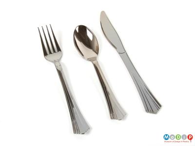 Top view showing a set of cutlery showing a fork, spoon, and knife.