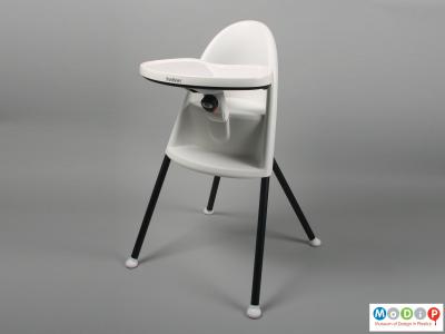 Front view of a highchair showing the table in the widest position.