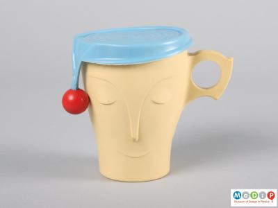Front view of a mug showing the hat cover.