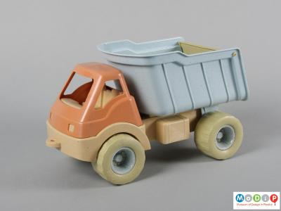 Side view of a toy truck showing the pale colours.
