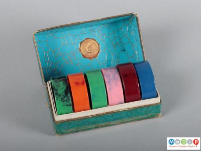 Top view of a box of napkin rings showing the open box.