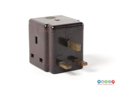 Side view of an IRL 3-pin plug adapter showing the 3 pins at the front and one of the sockets on the side.