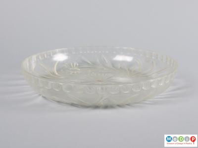 Side view of a fruit bowl showing the cut glass style patterning.